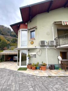 a house with potted plants in front of it at Villa Delia in Cernobbio