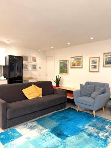 a living room with a couch and a chair at Villa Delia in Cernobbio