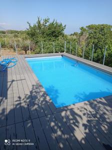 a swimming pool on top of a wooden deck at Holiday Homes in Campofelice di Roccella