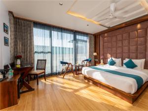 a bedroom with a large bed and a desk and a table at Moustache Select Mcleodganj in Dharamshala +63 photos