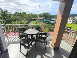 a patio with a table and chairs on a balcony at Private Resort in Batangas in Lian