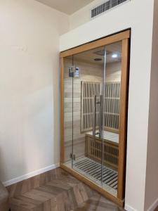 a walk in shower in a room with a glass door at מלון ארנה בת ים - קומת סוויטות הגן עם סאונה פרטית in Bat Yam