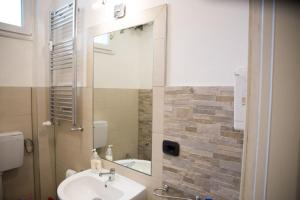 a bathroom with a sink and a mirror at Bed & Breakfast Delle Rose in Conegliano