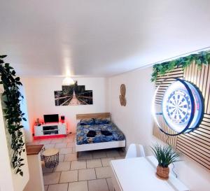 a bedroom with a bed in a room with a window at studio cosy & fun face aux château fléchettes in Gaillon