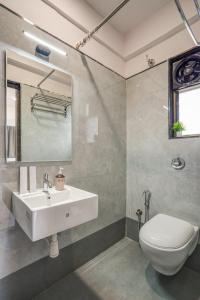 a bathroom with a white sink and a toilet at Hotel Zenora in Méribel Village +21 photos