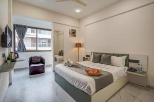 a bedroom with a large bed and a chair at Hotel Zenora in Méribel Village