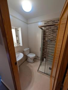 a bathroom with a toilet and a glass shower at Hostal El Convent de Moncada in Moncada +54 photos