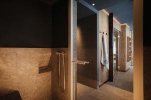 a bathroom with a shower with a glass door at Residence Ciasa Vedla in Badia +82 photos