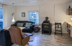 a living room with a couch and a stove at Beautiful Home In Toftlund With Wifi in Toftlund