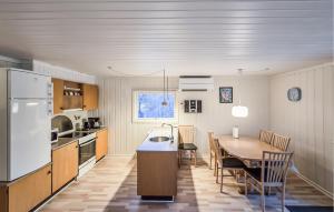 a kitchen and dining room with a table and a refrigerator at Beautiful Home In Toftlund With Wifi in Toftlund