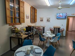 a restaurant with tables and chairs in a room at Hostal El Convent de Moncada in Moncada