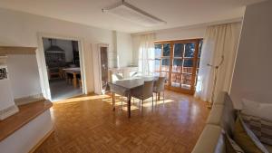 a living room with a table and chairs and a couch at Ferienwohnung Dirscherl in Tiefenbach