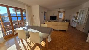 a living room with a table and chairs and a couch at Ferienwohnung Dirscherl in Tiefenbach