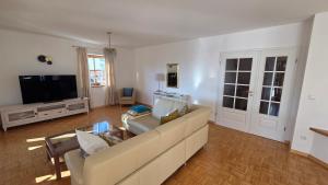 a living room with a couch and a tv at Ferienwohnung Dirscherl in Tiefenbach