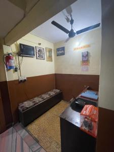 a room with a bed and a ceiling fan at Shivangi hotel in Bareilly