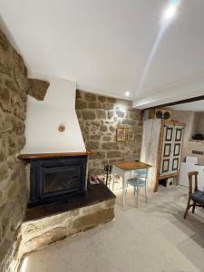 a living room with a fireplace and a table at Casa Brillantes in Ayerbe