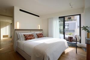 a bedroom with a large white bed and a window at Bellén Athens Ηotel in Athens +43 photos
