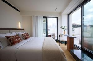a bedroom with a large bed and a desk at Bellén Athens Ηotel in Athens