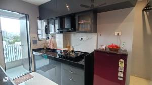 a kitchen with a stove and a counter top at Sylevo 2bhk Baner in Pune