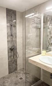 a bathroom with a shower and a sink at Семеен хотел Сирена in Ahtopol +182 photos