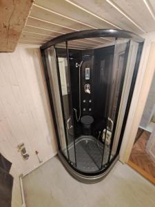 a bathroom with a glass shower in a room at Parkal Apartments in Paide