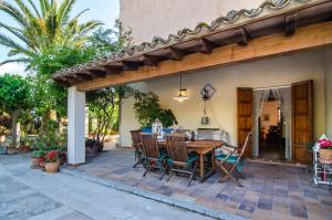 an outdoor patio with a wooden table and chairs at Sort Nova in Montuiri
