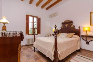 a bedroom with a large bed and a window at Sort Nova in Montuiri +16 photos