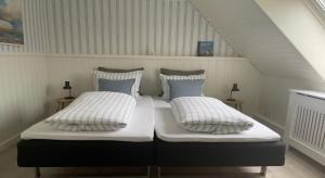 two beds with pillows on them in a attic at Als Kloster in Sønderborg