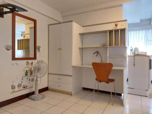 a room with a desk and a chair and a refrigerator at BaanSathorn21 in Bangkok