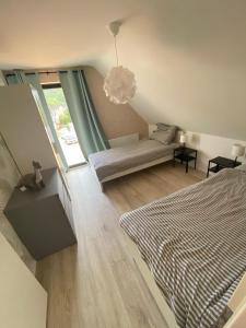 a bedroom with a bed and a couch and a window at Relaxen am Waldesrand Fewo 2 in Ahrbrück