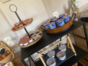 a table with two tiers of food on top at HOSTEL B&B Mama Mia - Budgetverblijf in Zaton Obrovački +74 photos