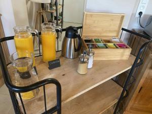 a table with two glasses of orange juice and a box at HOSTEL B&B Mama Mia - Budgetverblijf in Zaton Obrovački