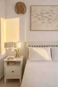 a bedroom with a bed and a nightstand with a lamp at A casa del nonno Jack in Letojanni