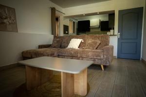a living room with a couch and a coffee table at Le Cocon de Bagatelle in Sainte-Suzanne