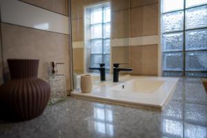 a bathroom with a sink and a mirror at Le Cocon de Bagatelle in Sainte-Suzanne +14 photos