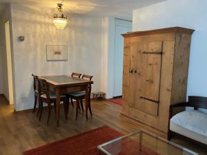 ein Esszimmer mit Tisch, Stühlen und einem Schrank in der Unterkunft Valbella in Davos
