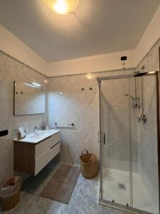 a bathroom with a sink and a shower at Mille4 in Novara +26 photos