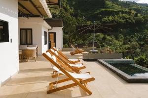 a group of chairs and an umbrella on a patio at Casa Margarita Loft in Buenavista +45 photos