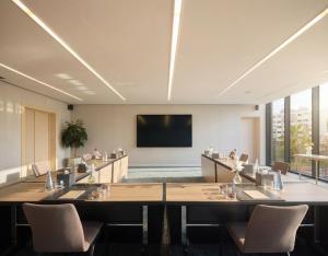 a conference room with a large table and a flat screen tv at The View Rabat in Rabat