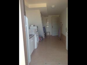 a hallway of a kitchen with a white refrigerator at A Stalla in Piana