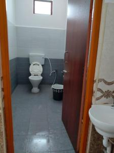 a bathroom with a toilet and a sink at R R Paradaise in Pūtalapattu +4 photos