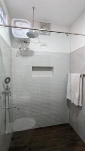 a bathroom with a shower with a glass door at The Ocean Breeze Villa in Tangalle +41 photos