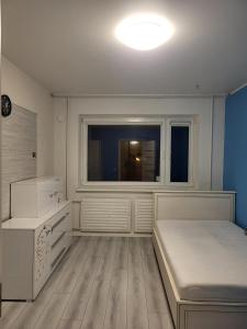 a bedroom with a bed and a window at A 3-bedroom apartment on the second floor in Tallinn