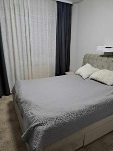 a bedroom with a bed and a window with curtains at A 3-bedroom apartment on the second floor in Tallinn +5 photos