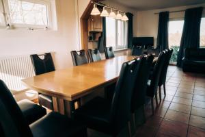 a dining room with a wooden table and chairs at Ferienhaus Ostsee in Rabenkirchen-Faulück