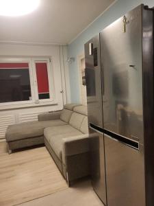a living room with a couch and a refrigerator at A 3-bedroom apartment on the second floor in Tallinn