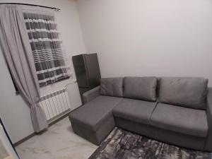 a living room with a couch and a window at Eghipatrush Guesthouse in Aparan