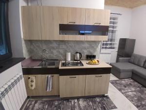a small kitchen with a sink and a stove at Eghipatrush Guesthouse in Aparan