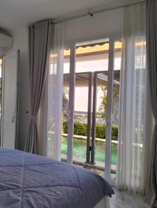 a bedroom with a bed and a large window at Aroha Villa in Banjar +70 photos