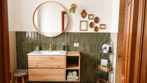 a bathroom with a sink and a mirror at AMY B&B - Casetta di Charme in Vercelli